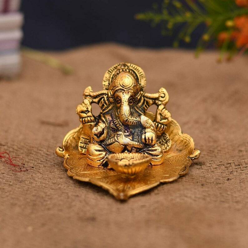 Lord Ganesh Idol Statue On Lotus Flower Diya