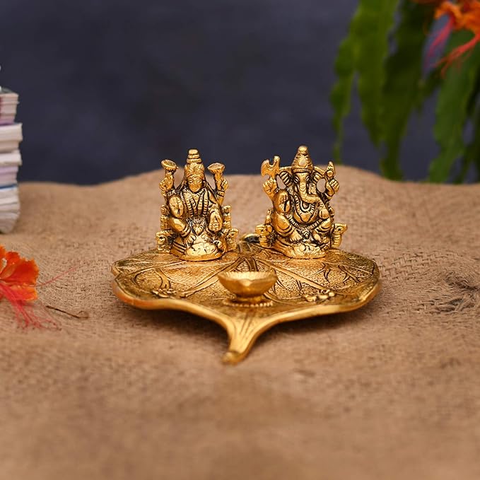 Lakshmi and Ganesha on Leaf with Diya