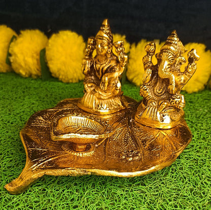 Lakshmi and Ganesha on Leaf with Diya