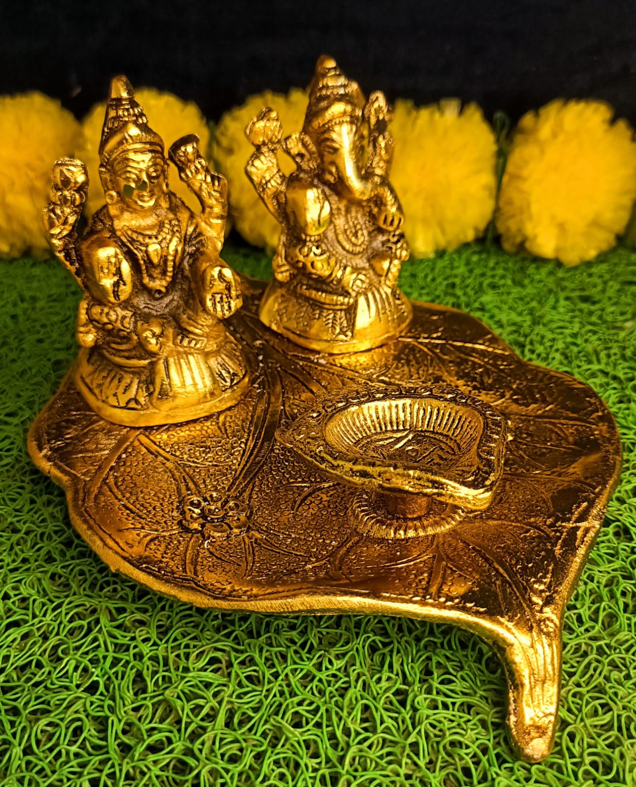 Lakshmi and Ganesha on Leaf with Diya