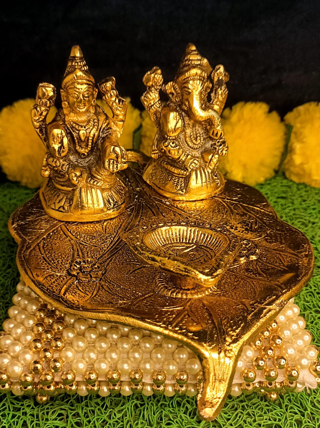 Lakshmi and Ganesha on Leaf with Diya