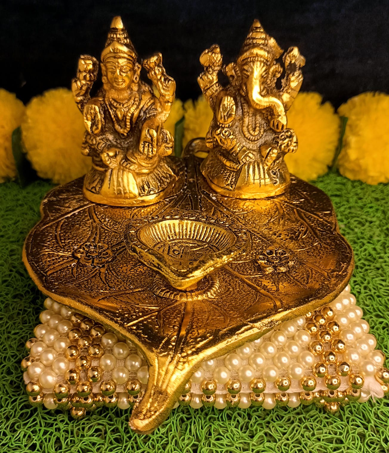 Lakshmi and Ganesha on Leaf with Diya